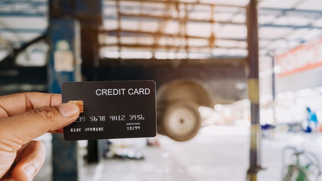 hand holding credit cards auto repair shop 73622 1738