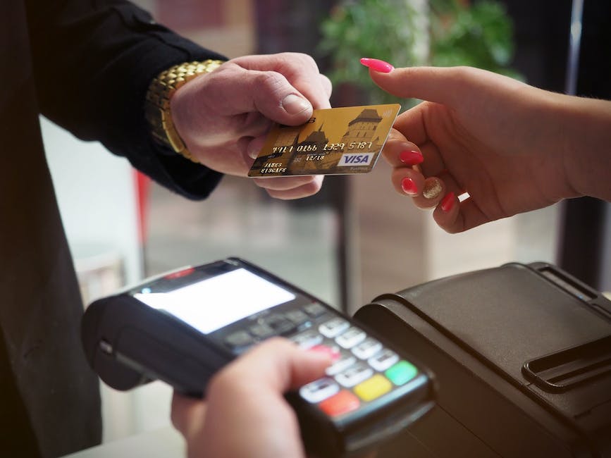 An illustration of hands holding a credit card, representing credit card processing and payment transactions.