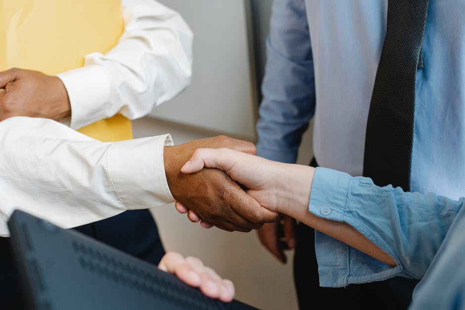 A group of businesspeople discussing financial transactions and credit card processing services.